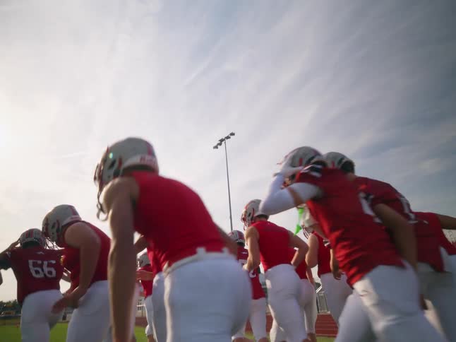 American football team cheering and entering the field