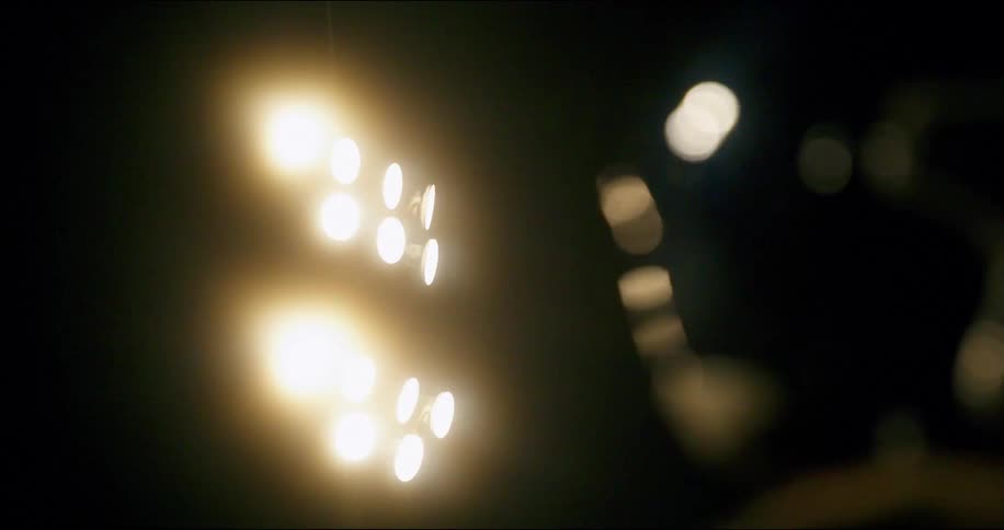 Stadium lighting reflects off surface of helmet