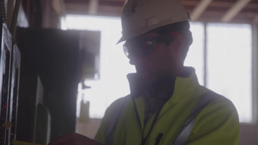 Engineer on a construction site consulting the electrical part