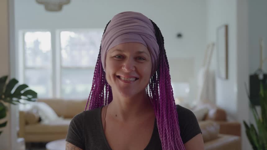 Woman with a headband on her forehead with a happy expression