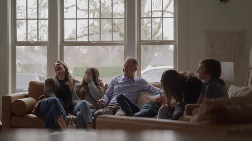 Family sitting on the couch enjoying time together in the living room