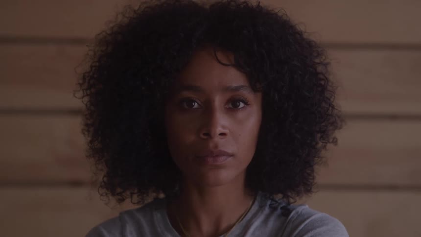 The woman turns her head and blinks her eyes