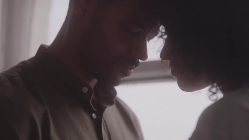 A couple a man and a woman dancing romantically with their foreheads touching and eyes closed