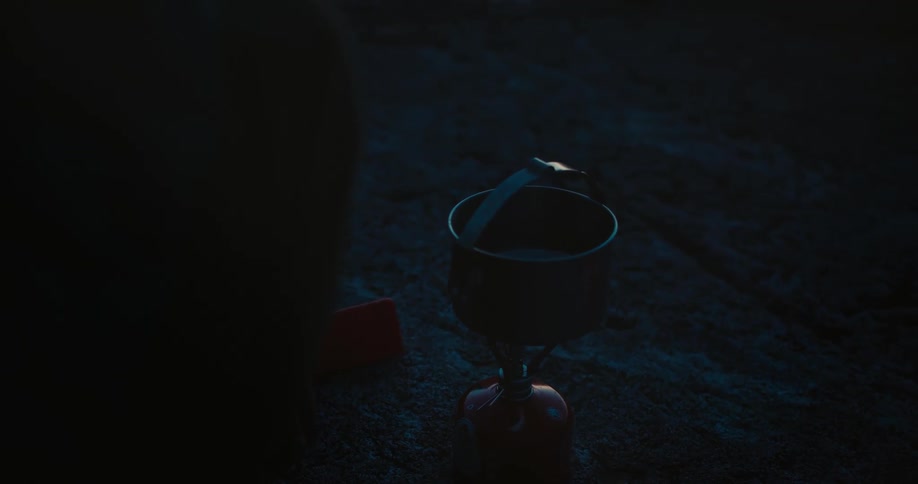 A pot is heating at the camp site