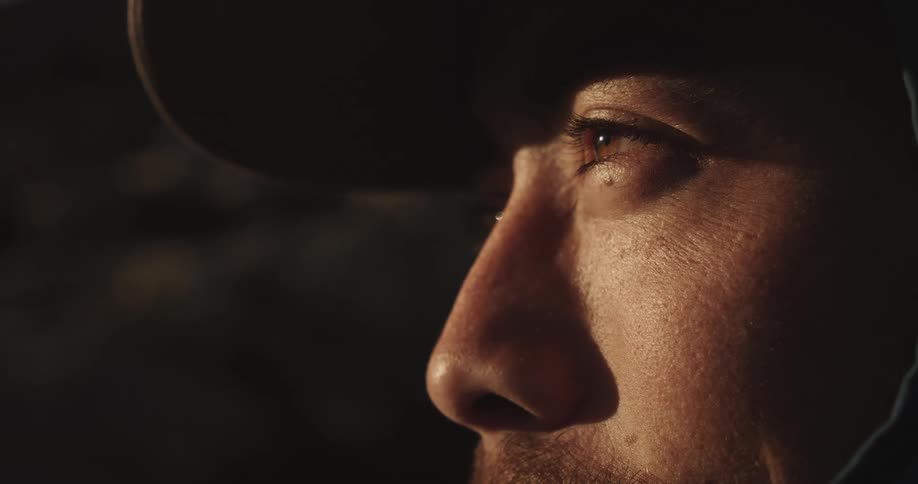 Closeup of a face lit by the sun highlights the focused gaze