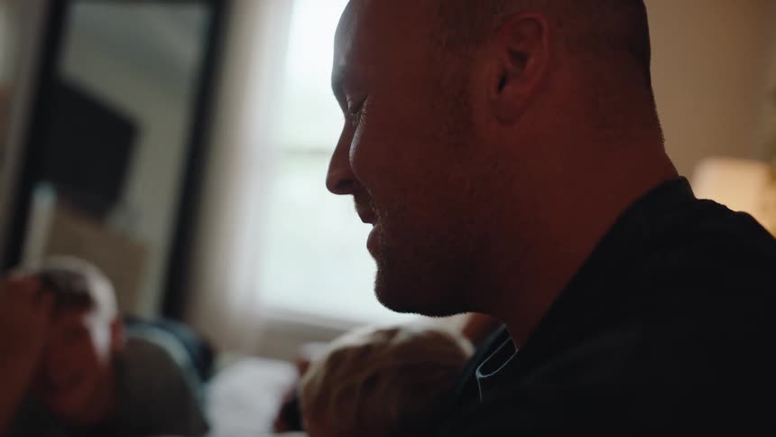 Side portrait of a man talking with some people around