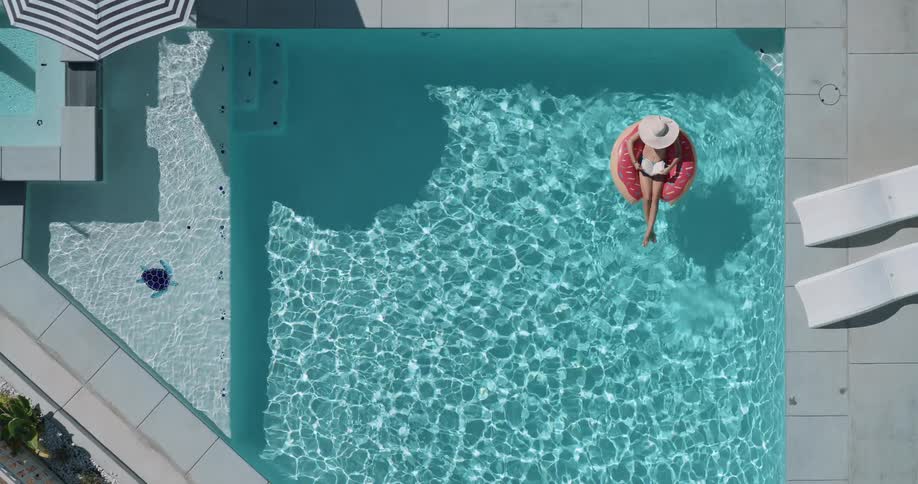Woman sitting on a float in the pool