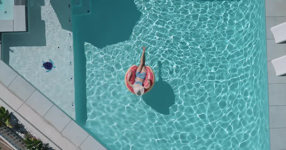 Woman sitting on a float relaxing in the pool