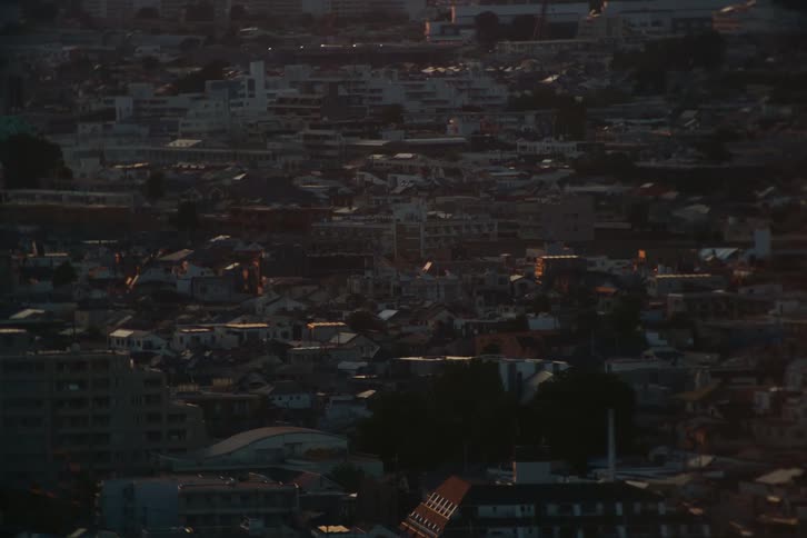 Train passes through a residential neighborhood in the evening