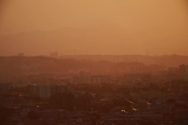 Panorama of an urban city against a reddish sky