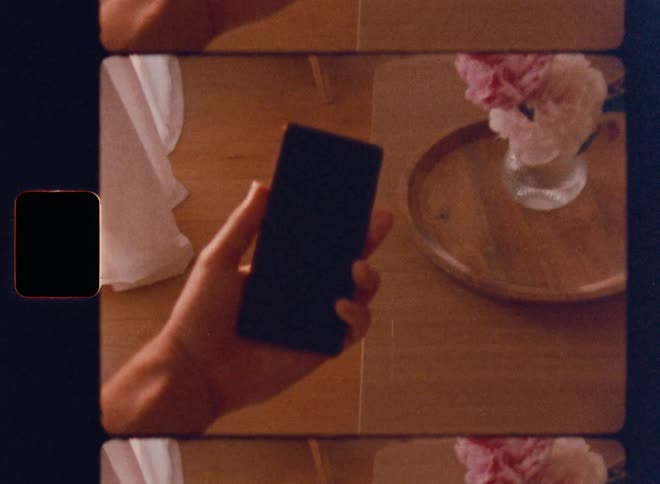 The person holds out a cell phone