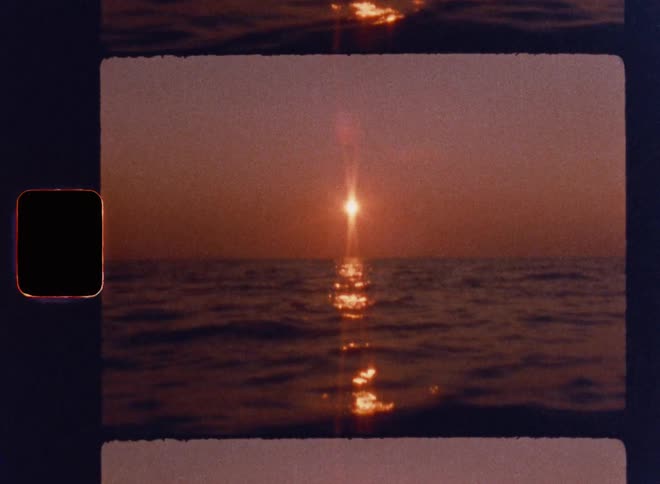 Cinematic Super 8mm sunset over calm ocean waters with a glowing golden light path, soft rippling waves, warm red-orange sky, natural lens flares, and authentic vintage film strip frame capturing a nostalgic seascape atmosphere