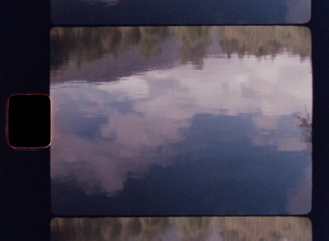 Calm lake reflects the blue sky with clouds