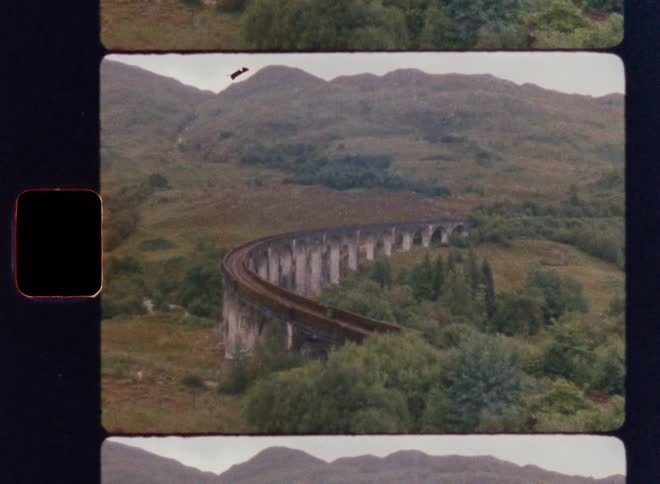 A railway on an overpass runs by the mountain
