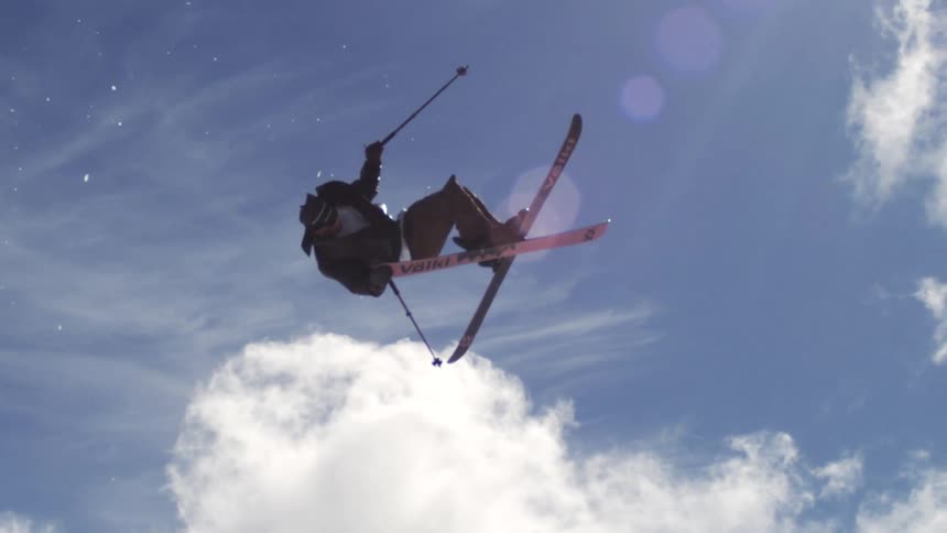 Person suspended in the air doing a snowboard maneuver on a snow slope