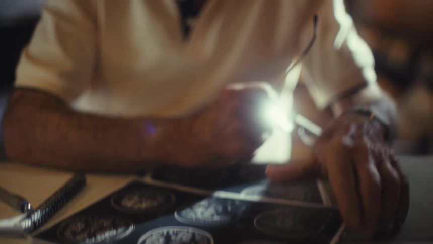 Elderly patient wearing an oxygen tube looks through medical images at home during the daytime