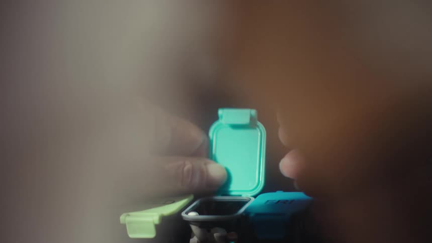 A pill is dropped into the organizer