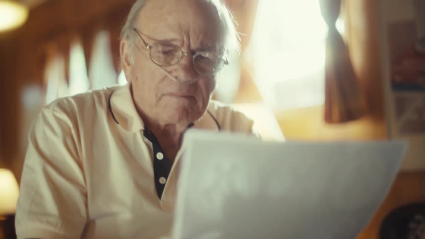 The man is viewing a print out of a ct scan