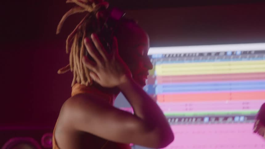 Two women in a studio facing a music mixing screen