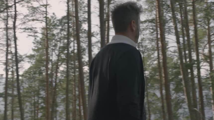 A man is hiking in the forest