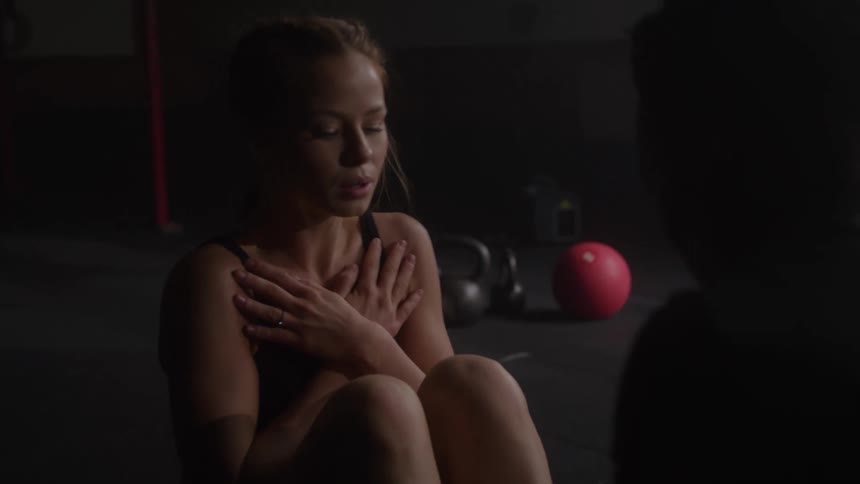 Woman does two sit ups and then high fives someone