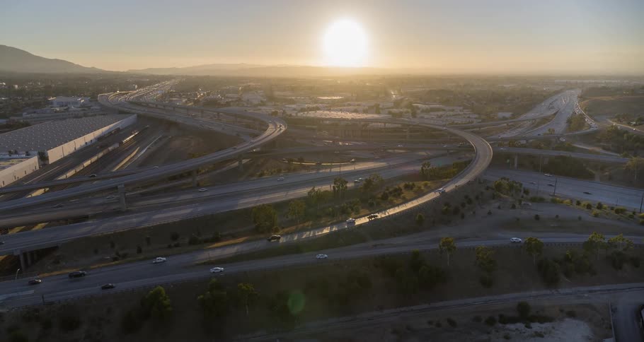 Aerial of busy overpasses and freeways in a metropolitan city during daytime
