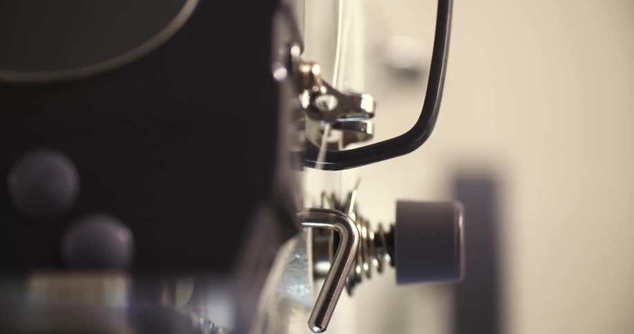 A closeup shot of a sewing machine threading mechanism in motion