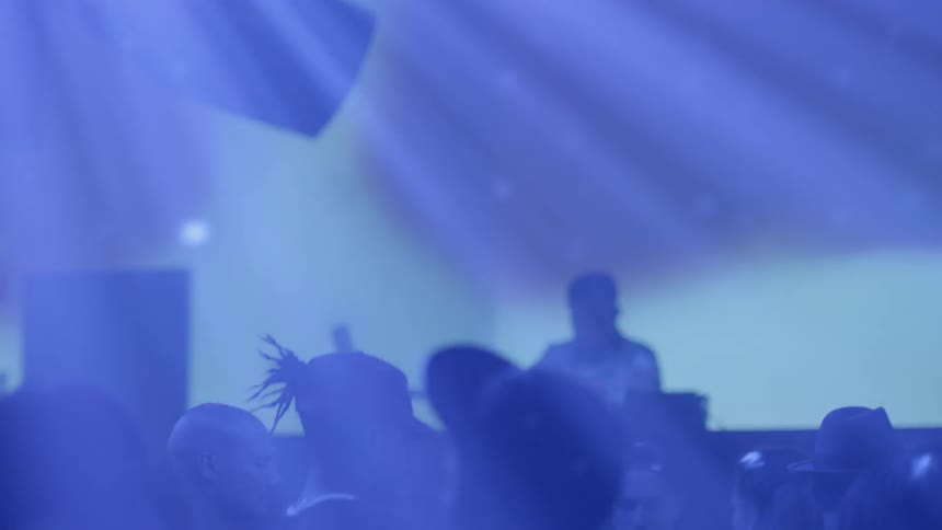 A dj plays in a club