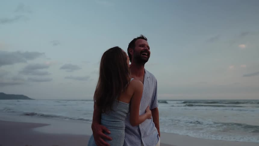 Couple hugging smiling on the beach