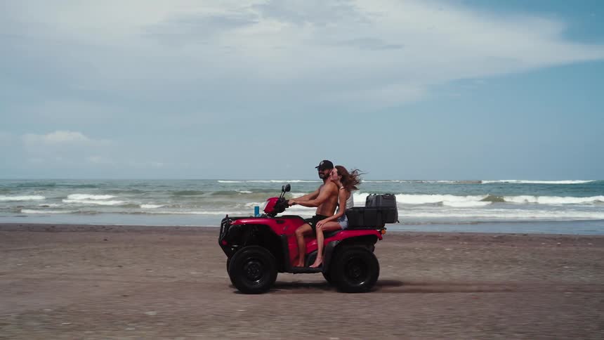 Couple riding a buggy on the beach