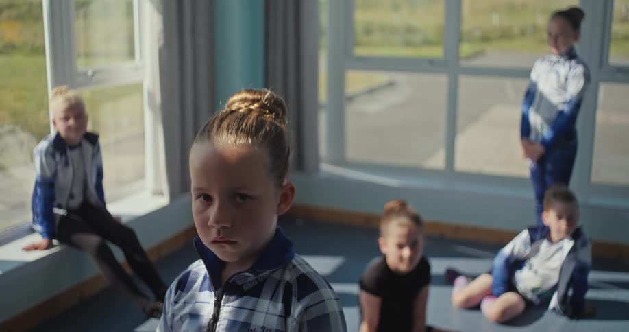 Children are sitting and standing in the room
