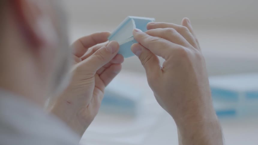 A man folds together some pieces