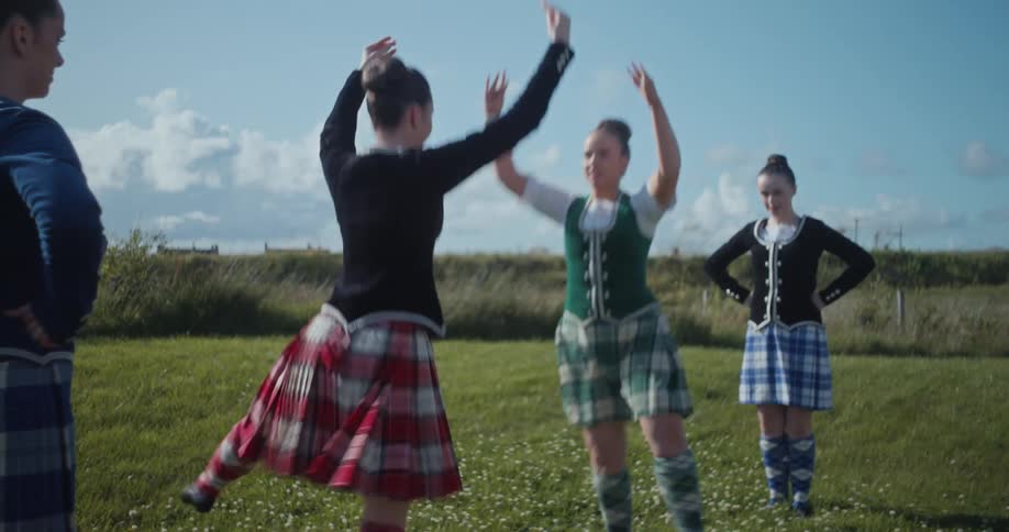 Four women in a field dancing