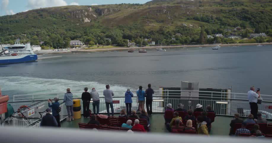 People enjoying the sea scenery on a moving boat