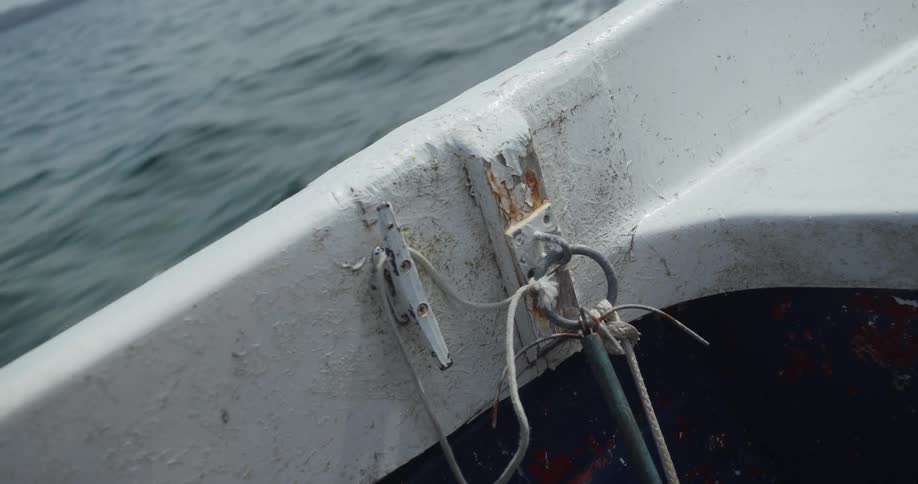 The boat is traveling by the shore