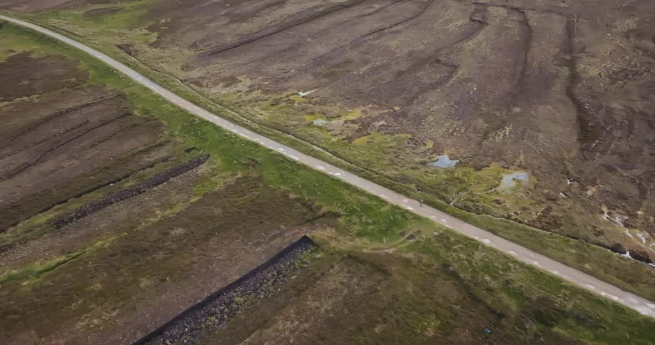 A long road cuts through the land