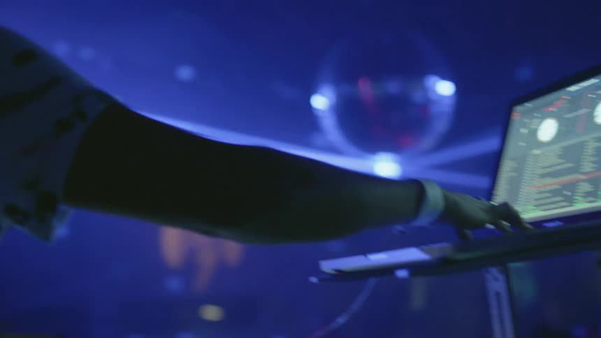A dj is on stage performing for a crowd