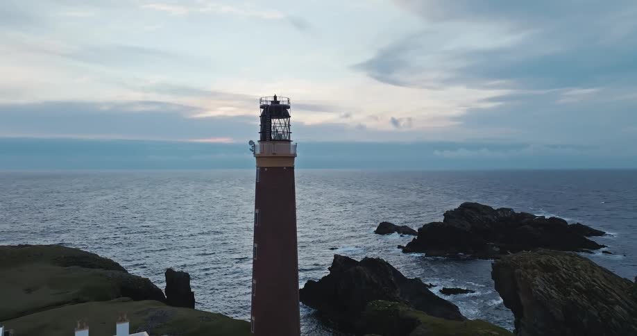 A tall lighthouse is right on the shore line