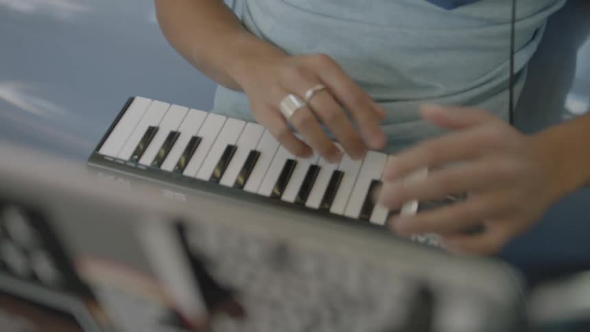 A man is playing a midi board