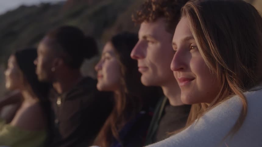 Group of friends sitting outdoors with happy expression