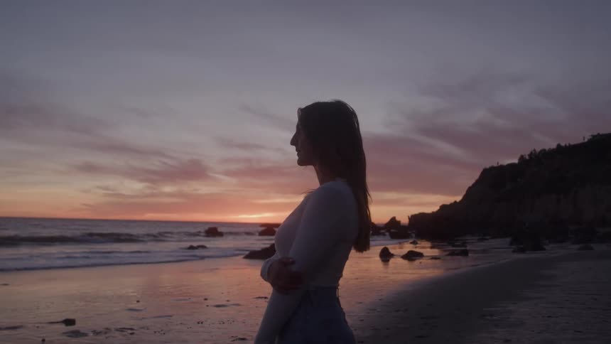 The woman watches the sunrise