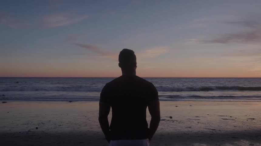Man enjoying the sunrise on the beach