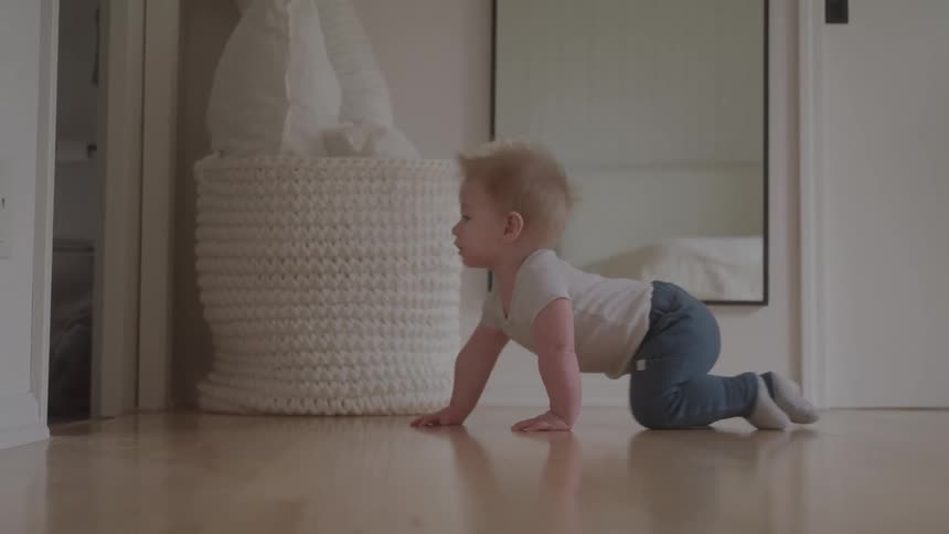 Blonde baby crawling around the house