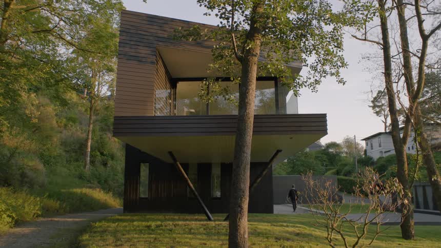 A person walks towards a house