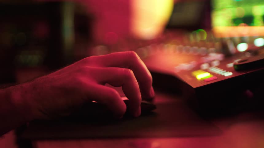 The man is using the mouse by the soundboard