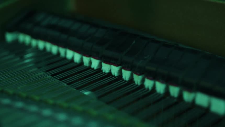 Hammers inside a piano move to strike its strings