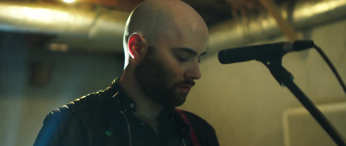 Male musician focused on the microphone