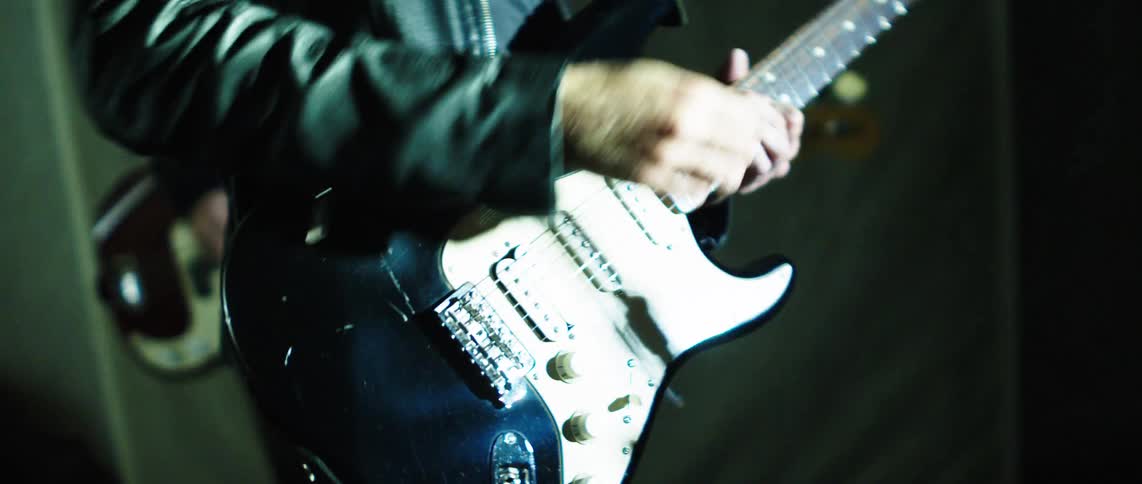 Person in a performance playing guitar