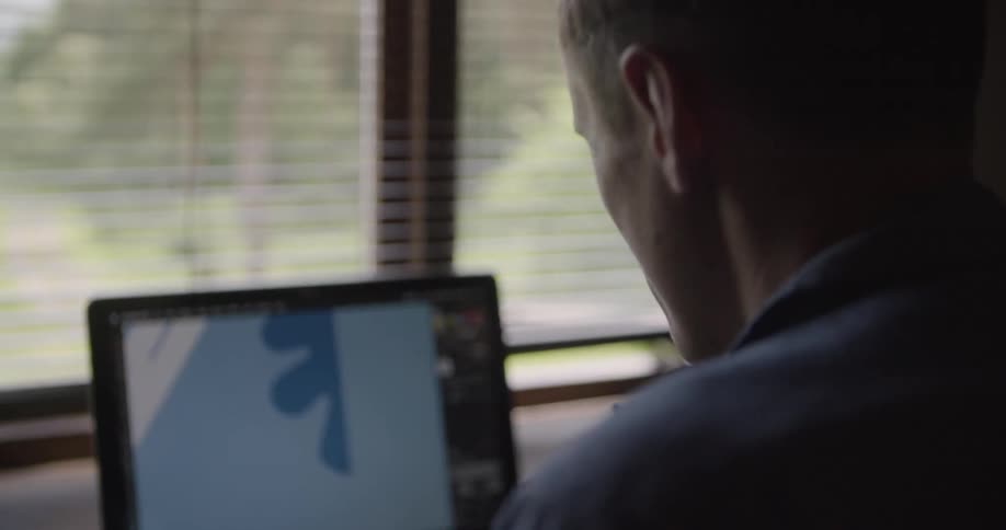 Man sitting working in front of laptop