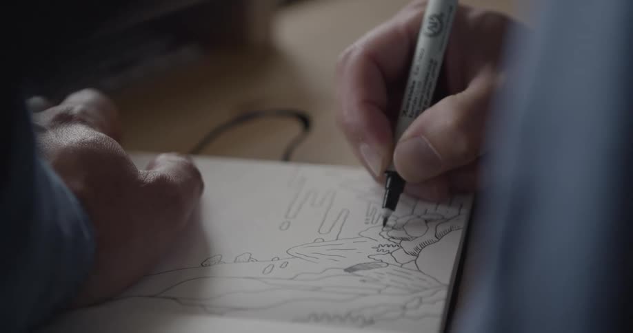 Person with a pen drawing